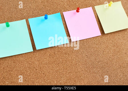 Cork board with pinned colored blank notes Stock Photo