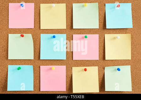 Cork board with pinned colored blank notes Stock Photo