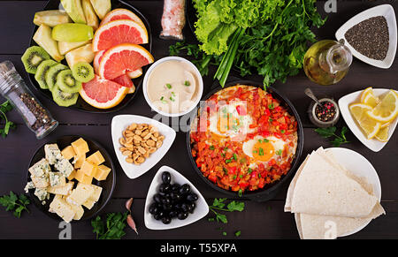 Turkish Breakfast -  shakshuka, olives, cheese and fruit. Rich brunch. Top view Stock Photo