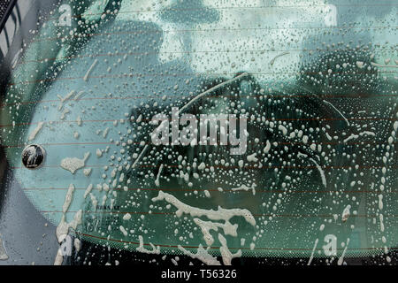 Dirty foam and soap on dark background. Abstract pattern, washing concept. Stock Photo