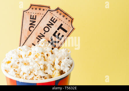 Movie tickets, film strips and popcorn on blue background. Copy space for text. Stock Photo