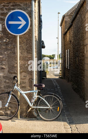 Barfleur, France - August 29, 2018: Medieval granite houses and bikes in Barfleur. Normandy France Stock Photo