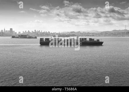 Moody Black And White Photo Of The Container Ship, MSC ARIANE, Steaming Through San Francisco Bay, Alcatraz To The Left And Behind. USA. Stock Photo