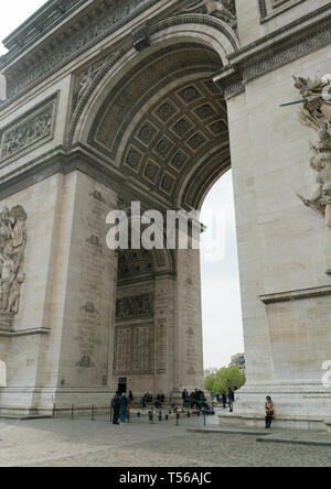 Paris, France - April 2, 2019: tourists under the Arc de Triomphe (Triumphal Arch) in Champs Elysees.