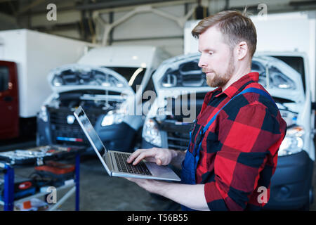Mechanic browsing in the net Stock Photo