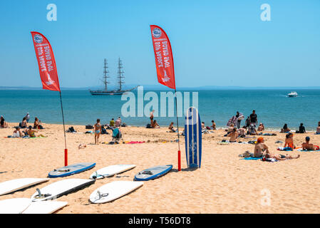 Cascais, Portugal - April 21st, 2019: Standup Paddle boards on beach at a crowded sandy beach in Cascais near Lisbon, Portugal Stock Photo