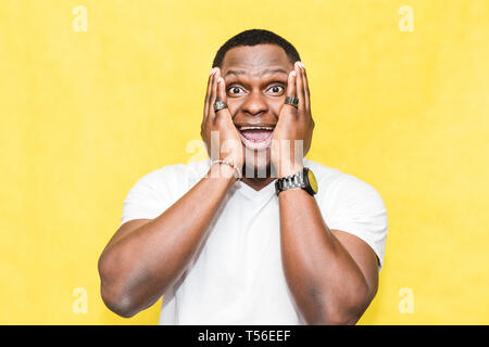 Amazed African American man looks with horror and panic, being shocked to hear bad news. Stock Photo