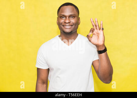 Handsome African American man shows ok sign. Body language concept. Stock Photo