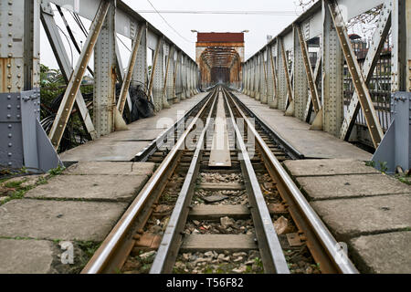 Old railroad bridge with rusty metal constructions Stock Photo