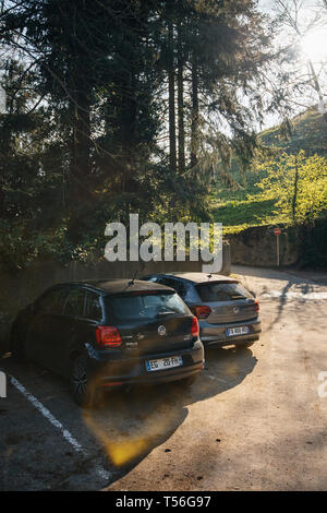 Ribeauville, France - Apr 19, 2019: Vertical image of multiple cars Volkswagen Golf and Polo mini cars parked in the large parking before the start of the hiking route Stock Photo
