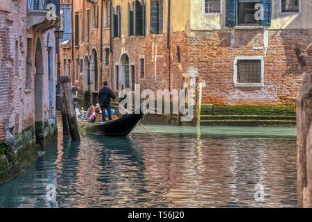 Romantic gondola ride in the canals of Venice, Italy, people unrecognizable Stock Photo