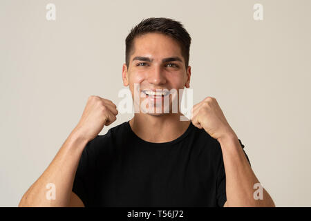 Portrait of handsome shocked young man hearing good news, winning or having great success with surprised happy face. Making cheerful gestures. Facial  Stock Photo