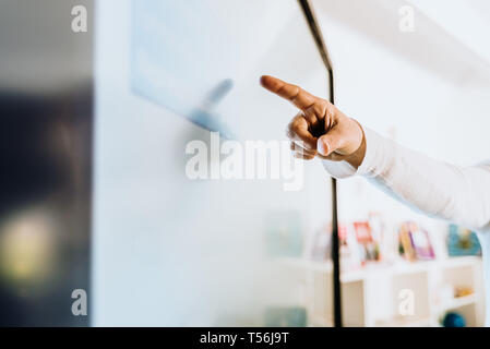 Teacher explaining some ideas on a touch TV to his students. Stock Photo