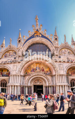 Venice, Italy - April 17 2019: Basilica San Marco on Saint Mark's Square. The iconic landmark of Venice attracts thousands of visitors each day.