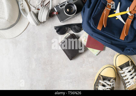 prepare backpack accessories and travel items on marble background, flat lay, top view background Stock Photo