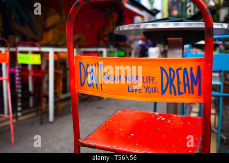 don't dream your life, live your dream - message on the back of a red chair Stock Photo