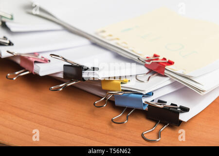 Paper business documents of unfinished stacked on office desk archive,in archive analyzing the market Stock Photo