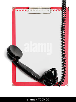 Clipboard with paper for your message and vintage phone receiver isolated on white with clipping path Stock Photo