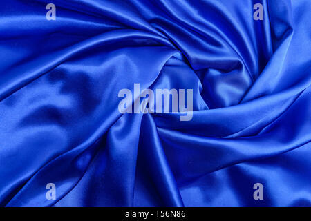 Elegant smooth soft curvy blue cloth - satin, silk, texture or background Stock Photo