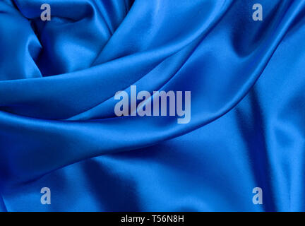 Elegant smooth soft curvy blue cloth - satin, silk, texture or background Stock Photo