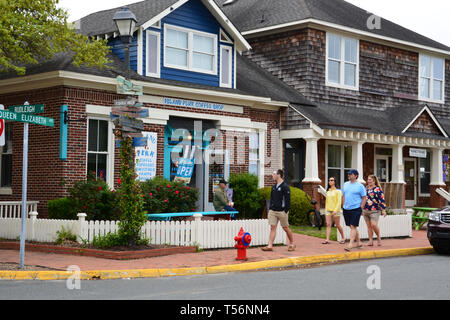 Tourists walk past the rustic shops of downtown Manteo on the Outer Bank's Roanoke Island, North Carolina. Stock Photo