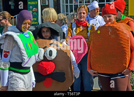 A cartoon characters team taking part in the annual Good Friday Marbles Competition in fancy dress in Battle Market Square, Battle, East Sussex, UK Stock Photo