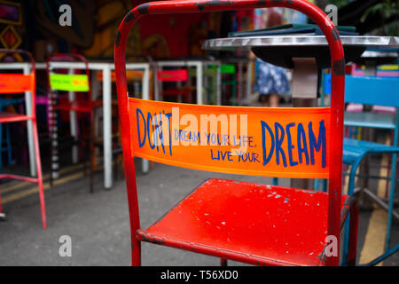 don't dream your life, live your dream - message on the back of a red chair Stock Photo