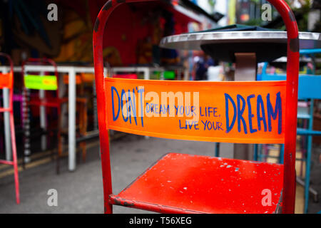 don't dream your life, live your dream - message on the back of a red chair Stock Photo