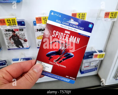 PLATTSBURGH, USA - JANUARY 21, 2019 : Full game download card of Spider man video game in a hand of a buyer at Walmart store. Stock Photo