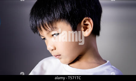 Portrait of angry tricky boy looking at camera Stock Photo