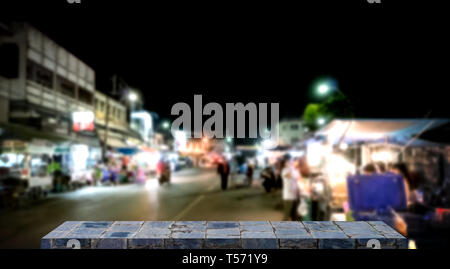 Empty stone shelf display with night market background Stock Photo