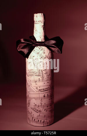 closeup.festively decorated bottle of wine.isolated on a dark background.photo with copy space Stock Photo