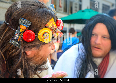 London, UK, 21th April 2019. A Jesus with Cheeses. The group of Jesus 'reincarnations' at one of their first stops, where the last supper is duly re-inacted with a pint and pub food. Participants dressed as Jesus and other biblical and related figures, complete with fold-out musical crucifix take part in this annual alternative pub walk along a route of biblically named pubs, raising money for a charitable cause. Credit: Imageplotter/Alamy Live News Stock Photo