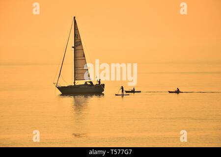 Aberystwyth, Wales, UK. 21st Apr 2019. Sunset at the end of A wonderfully warm and sunny Easter Sunday evening in Aberystwyth Wales as the country enjoys the gloriously hot Bank Holiday  weather. The temperature reached 23 degrees Celsius at Trawsgoed just inland from the town, making it the hottest ever Easter Sunday in Wales   Credit: Keith Morris / Alamy Live News Stock Photo