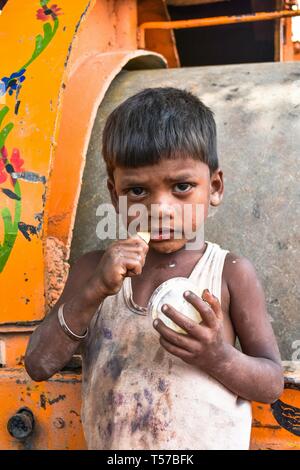 An Indian boy seen eating ice cream in district the Patiala in Punjab, India. Punjab, a state bordering Pakistan, is the heart of India’s Sikh community.  The state is bordered by the Indian states of Jammu and Kashmir to the north, Himachal Pradesh to the east, Haryana to the south and southeast, Rajasthan to the southwest, and the Pakistani province of Punjab to the west. Punjab is primarily agriculture-based due to the presence of abundant water sources and fertile soils. The population of Punjab was estimated to be 30,452,879 (30.4 million) in 2018. Stock Photo