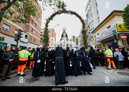 The image of Virgin Mary seen crossing a rosemary arch decorated with oranges, lemons and the Spanish flag during the traditional procession of Easter Sunday. The procession has been celebrated since the 18th century and is a tourist attraction in the region. Christian believers around the world mark the Holy Week of Easter celebrating the crucifixion and resurrection of Jesus Christ. Stock Photo