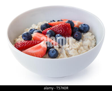 Homemade oatmeal with blueberries and strawberries in bowl isolated on white background. Healthy breakfast. Stock Photo