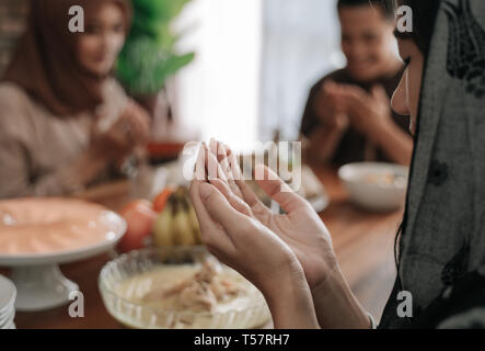 hand muslim praying in dining room before eating Stock Photo