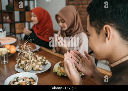 muslim people praying before having their food Stock Photo