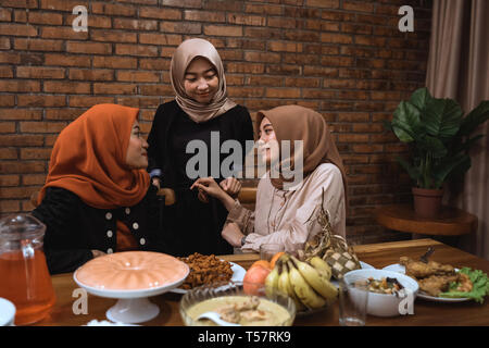 muslim woman talk to each other while dinner Stock Photo