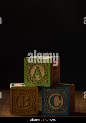 Wooden Blocks on a rustic wood table Stock Photo