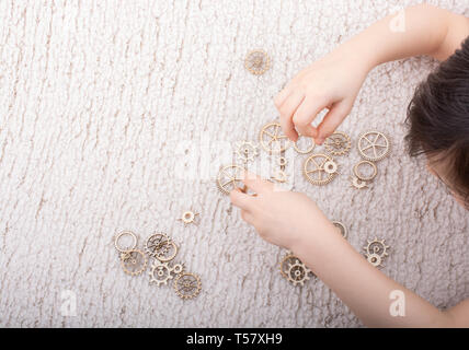 Hand holding gear wheels as the concept of mechanism Stock Photo