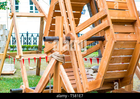 ancient catapult on the ramparts of Alghero ,Sardinia Island, Italy , Defensive wall. Catapult in the downtown of the citywith the sea as background a Stock Photo