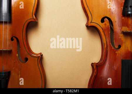 Two grunge old violin on vintage yellowed paper Stock Photo