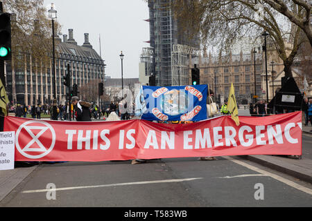 Extinction Rebellion protesters seen behind a large and wide banner during a protest in London. Stock Photo