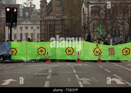Extinction Rebellion protesters seen behind a large and wide banner during a protest in London. Stock Photo
