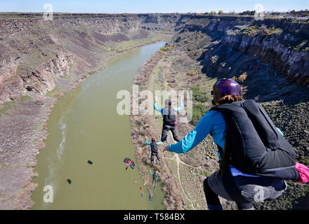 Multiple exposures of base jumper. View from the top of the Perrine Bridge, landing on the shore of the Snake River Canyon in Idaho. Stock Photo