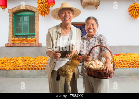 Farmers couples in the farmyard Stock Photo