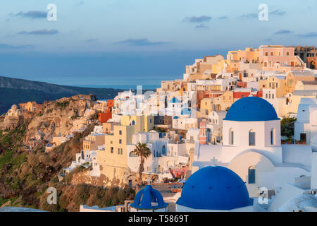 Sunrise at blue and white domed churches on Santorini Greek Island, Oia town, Santorini, Greece. Stock Photo