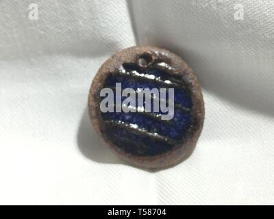 A ceramic pendant made by a local potter Stock Photo